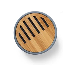 A round Bluetooth speaker with a bamboo top and grey sides, featuring cutouts for sound emission.