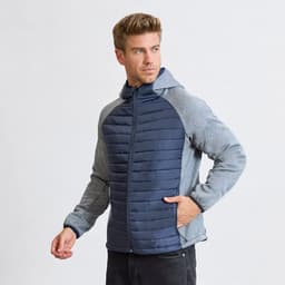A man wearing a navy and grey soft shell jacket with a hood, featuring a zip front and side pockets.
