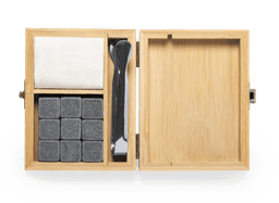 Bamboo box containing grey stone ice cubes, a black scoop, and a white cloth for storage.