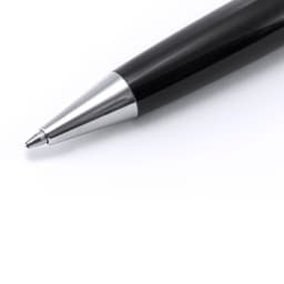 A black metal pen with a silver tip is prominently featured in the image. The pen has a sleek design and a logo on it.