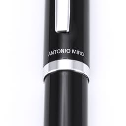 A black metal pen with a silver clip and branding. The pen features a sleek, modern design.