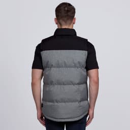 A puffa vest in grey and black with a branding logo, featuring a padded design and a collar.