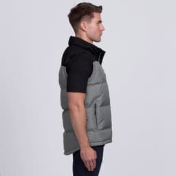 A grey and black puffa vest with a high collar and zippered pockets is displayed on a model from the side.