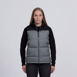 A grey and black puffa vest with a zip front and a logo, displayed on a model against a plain background.