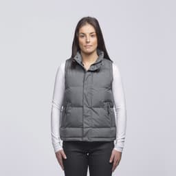 A grey puffa vest with a collar and pockets, worn over a white long-sleeve top. The model stands against a plain background.