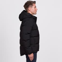 A black puffer jacket with a hood, featuring zippers and a logo, displayed on a male model from the side.