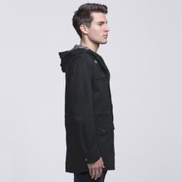 A black Heritage Twill Jacket with a hood, featuring a side view of a model wearing it.