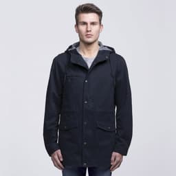 A navy blue twill jacket with a hood, featuring pockets and a grey lining, worn by a model.