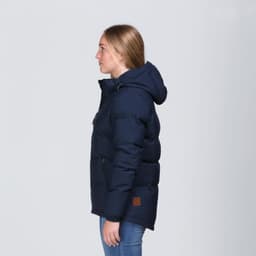 A navy blue puffer jacket with a hood, featuring a logo and side zip pockets, displayed on a model from the side.