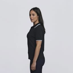 A black polo shirt with white striped detailing on the collar, modelled by a woman from the side.