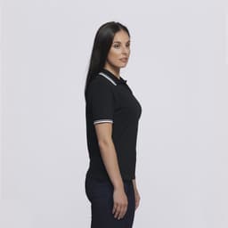 A black women's polo shirt with white stripe detailing, displayed on a female model in profile.