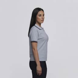 A grey women's polo shirt featuring a classic collar and contrasting trim. The shirt has a logo on it.