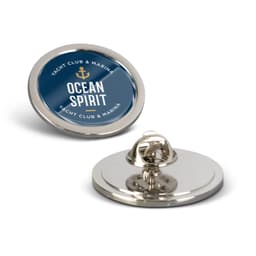 A round large lapel pin featuring a blue and gold design with a logo. The pin has a shiny silver backing.