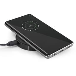 A sleek black wireless charger with a smartphone placed on top, displaying a charging status of 63%.