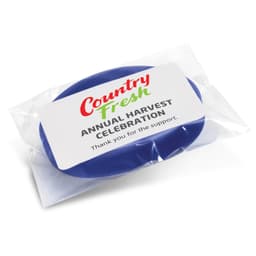 A blue silicone wristband packaged in clear plastic with a label featuring text and branding.