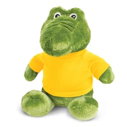 A green crocodile plush toy wearing a bright yellow shirt, featuring large eyes and a friendly expression.
