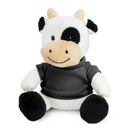 A plush cow toy with a black and white pattern, wearing a grey shirt, sitting upright with a friendly expression.