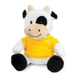 A plush cow toy with a black and white design, wearing a bright yellow shirt, featuring a smiling face.