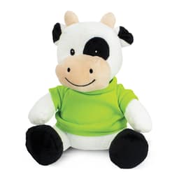 A plush cow toy with a black and white design, wearing a green shirt, featuring a friendly smile and soft texture.