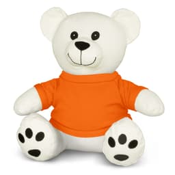 A white plush bear wearing an orange shirt, featuring black paws and a smiling face. It has a logo on the shirt.