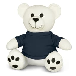 A white plush bear toy with a smiling face, wearing a navy blue shirt and black paw prints on its feet.