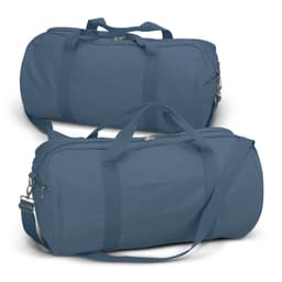 A canvas duffle bag in a deep blue shade, featuring dual handles and a detachable shoulder strap. It has a small front pocket and a logo.