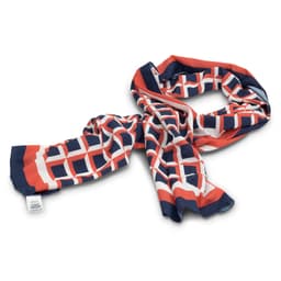A patterned scarf in navy blue, orange, and white, featuring a geometric design. It has a logo on one side.