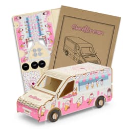 A pink and white wooden ice cream van model kit with assembly instructions and parts.