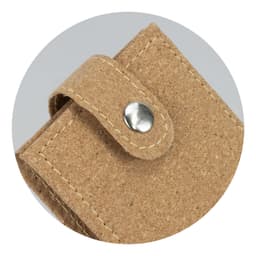 A cork manicure set with a snap closure, featuring a natural beige tone and textured finish. It has a logo.