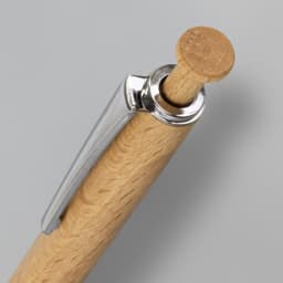 A close-up of a wooden pen with a silver clip and a wooden top. The pen features a natural wood finish.