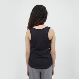 A women's sports tank top in black, featuring a simple sleeveless design and a smooth back.