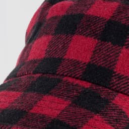 A red and black checkered Fiordland Bucket Hat with a wide brim and a textured fabric. It features a logo.