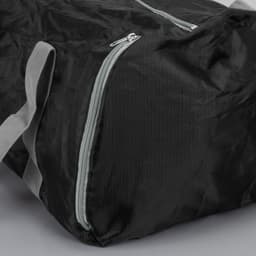 A black foldable duffle bag with grey handles and a zippered closure. It features a logo on the side.