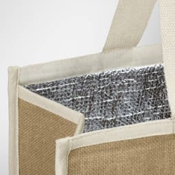 A jute cooler bag featuring a silver insulated interior and natural jute exterior with cream handles.