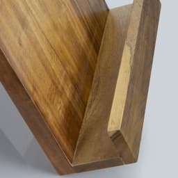 A wooden recipe book holder in a warm tone, featuring a slanted design for easy page viewing.