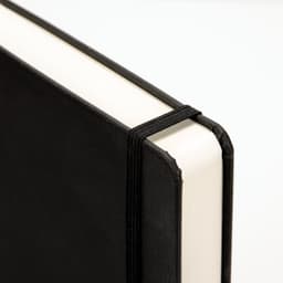 A5 daily diary in black, featuring a sleek cover and an elastic band closure.