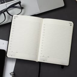 A5 daily diary for 2027, featuring blank pages for each day, with a black cover and a ribbon bookmark.