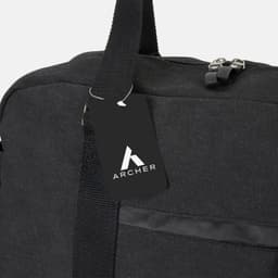 A black canvas duffle bag with a shoulder strap and a tag featuring a logo.