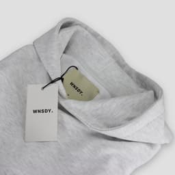 A grey hoodie with a hood and tags, featuring a logo on the tags.