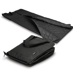 A black picnic blanket laid out flat, featuring a quilted texture, with a folded version showcasing a carrying handle.