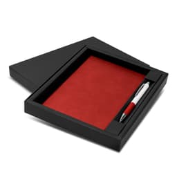 A black gift box containing a red notebook and a white and red pen, neatly arranged.