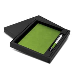 A green notebook and pen set displayed in a black box, featuring a smooth cover and a sleek pen.