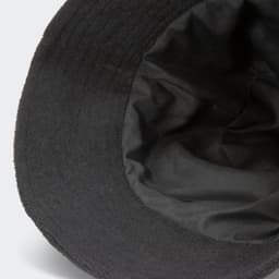 A black terry towelling bucket hat featuring a soft inner lining and a logo.